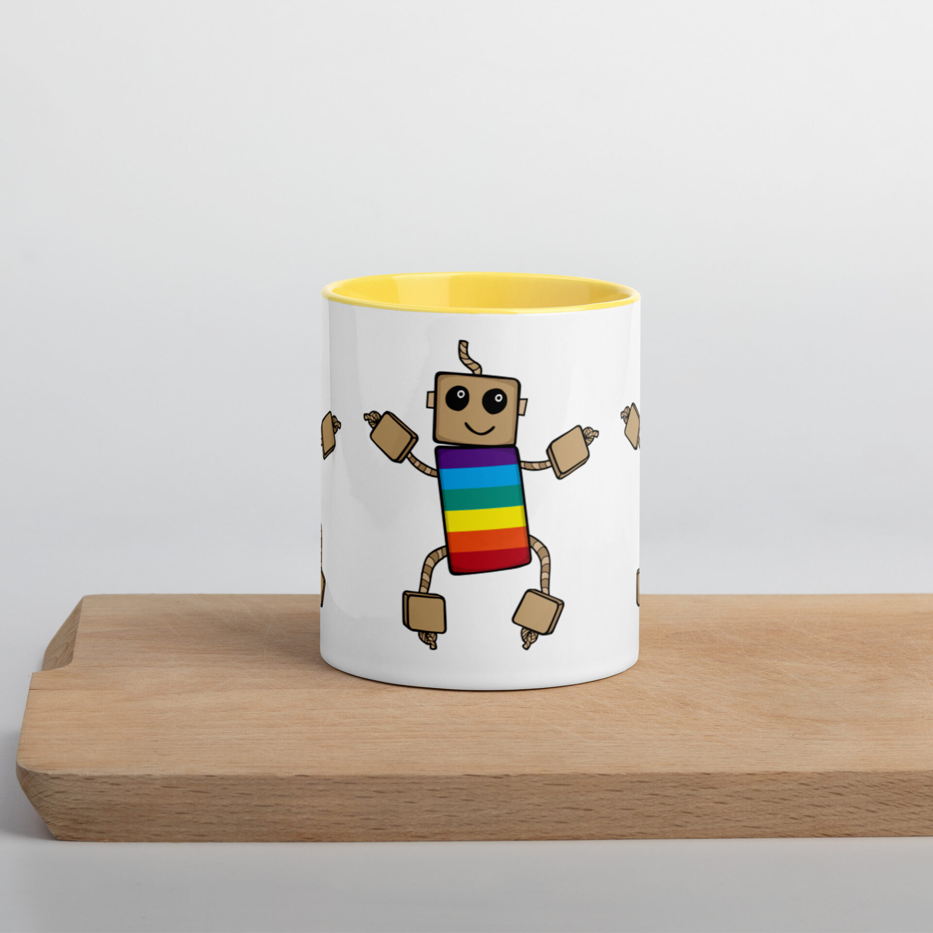 white mug with yellow inside and rainbow ned printed on the outside