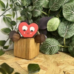 Mini red Heart with a face and arms, made out of walnut