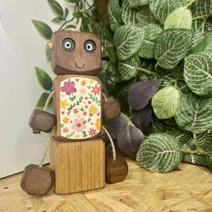 Bring you flowers Ned in walnut. Body painted with white background and colourful flowers and leaves - wooden robot