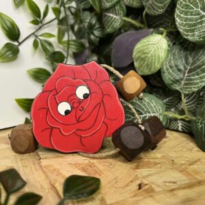 Wooden rose with arms and legs laying on its side