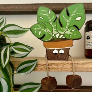 Monica Monstera wooden house plant in walnut with face on the pot and legs