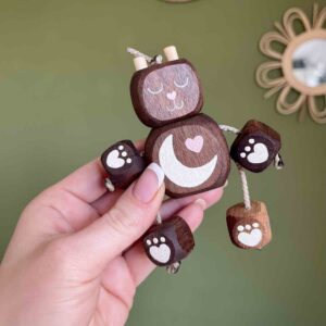 Handcrafted wooden Sleepy Moon Bear Podgy Ned toy made from walnut wood, featuring a crescent moon and heart design with moveable limbs.