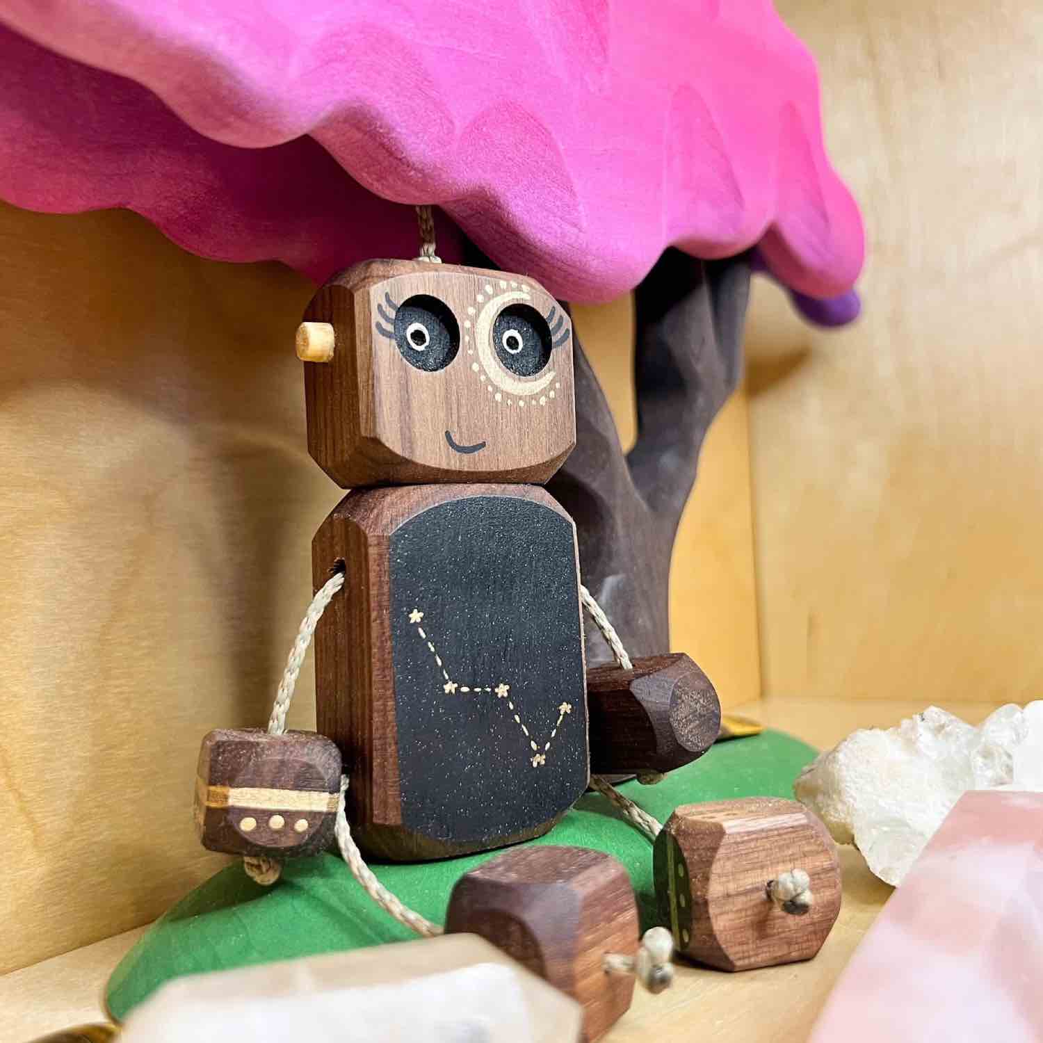 Hand-painted Cassiopeia Ned wooden robot in walnut by Rudi & Bear.
