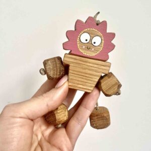 Handcrafted wooden Mama’s In Bloom plant pot Ned in oak with pink flower head by Rudi & Bear.