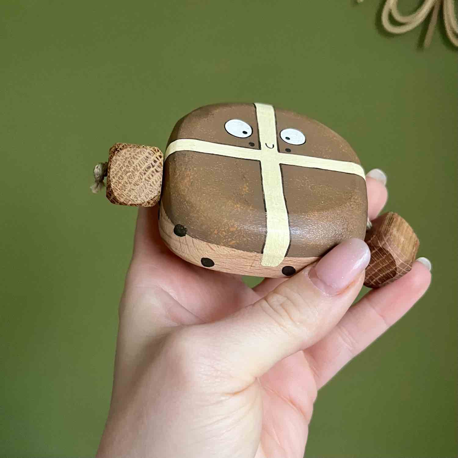 Hand painted wooden hot cross bun character with raisin details by Rudi and Bear